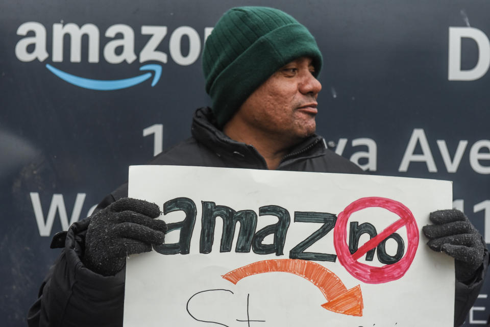 Immigrant and labor activists participate in a rally outside of a Amazon distribution center on December 16, 2019 in the Queens borough of New York City. (Photo by Stephanie Keith/Getty Images)