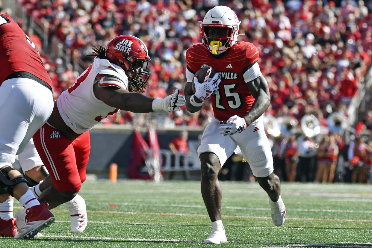 Jacksonville State defensive lineman Jawaun Campbell (93) attempts to stop Louisville running back Isaac Brown (25) during the first half of an NCAA college football game in Louisville, Ky., Saturday, Sept. 7, 2024. (AP Photo/Timothy D. Easley)