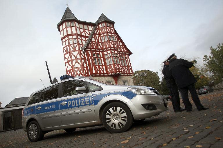 Policemen stand in front of the bishop's house near the cathedral on October 13, 2013 in Limburg an der Lahn, western Germany