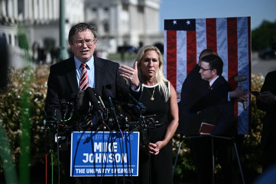 Republican Reps. Thomas Massie of Kentucky (left) and Marjorie Taylor Greene of Georgia call for the ouster of House Speaker Mike Johnson during a press conference outside the US Capitol in Washington, DC, on May 1, 2024. (Photo by Brendan SMIALOWSKI / AFP) (Photo by BRENDAN SMIALOWSKI/AFP via Getty Images)