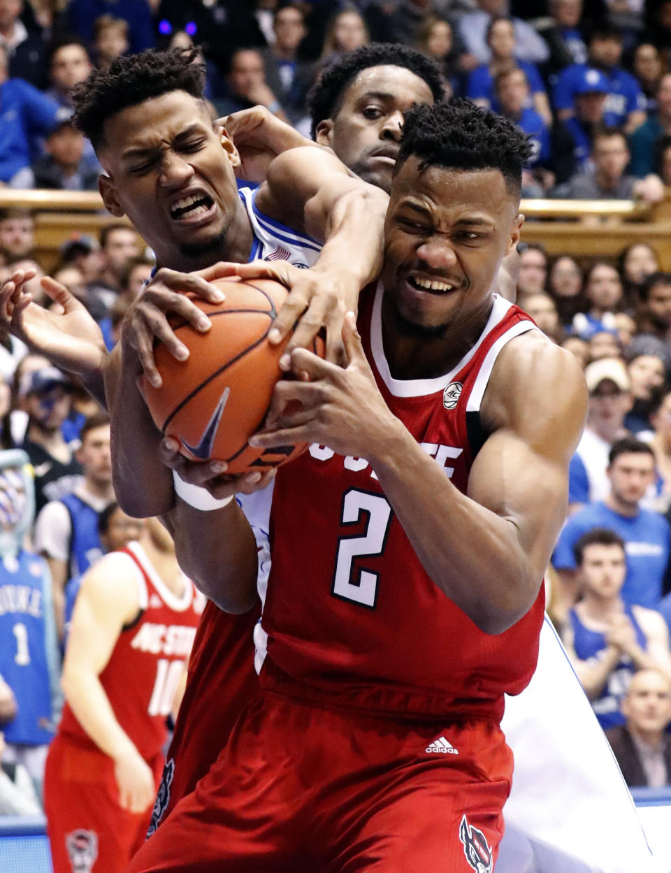 Duke's Javin DeLaurier (12) and North Carolina State's Torin Dorn (2) battle for the ball during the first half of an NCAA college basketball game in Durham, N.C., Saturday, Feb. 16, 2019. (AP Photo/Chris Seward)