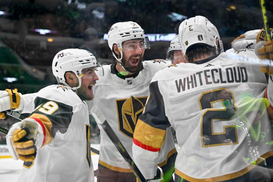 The Vegas Golden Knights' Ivan Barbashev (49), Nicolas Hague (14) and Zach Whitecloud (2) celebrates a goal scored by Jonathan Marchessault against the Dallas Stars during the Game 6 at American Airlines Center.