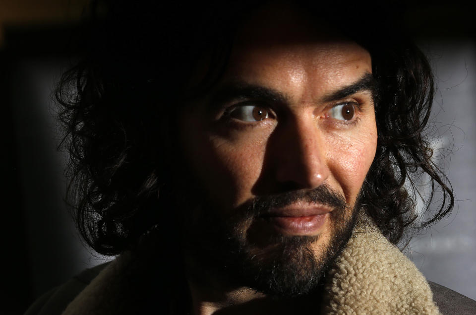 Comedian Russell Brand poses for photographers before signing copies of his new book entitled 