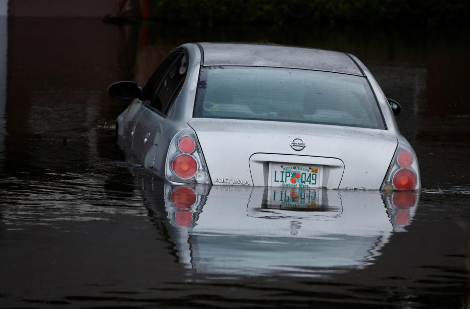 A partially submerged car sits after Hurricane Ian caused widespread damage and flooding in Kissimmee, Florida, U.S., September 29, 2022. REUTERS/Joe Skipper