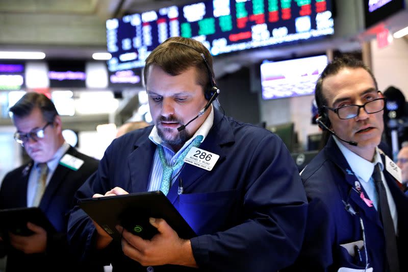 Traders work on the floor at the NYSE in New York