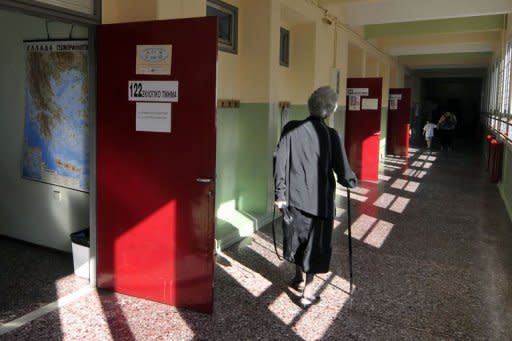 People arrive to vote at a polling station in Athens. Greece's two main pro-bailout parties have won enough votes to form a government in a cliffhanger election Sunday, first estimates showed, easing fears the stricken economy will crash out of the euro