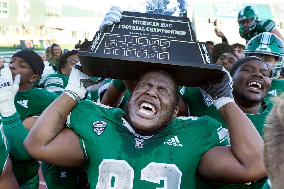 Eastern Michigan defensive lineman Jordan Crawford lifts the Michigan Mid-American Conference trophy after an NCAA college football game against Central Michigan, Friday, Nov. 25, 2022, in Ypsilanti, Mich. (AP Photo/Carlos Osorio)