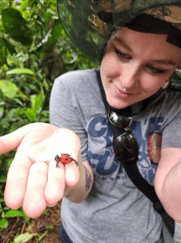 Summer Hatmaker holds a poison dart frog. “Your fingers might go a little numb,” she says, “but it’s temporary.”