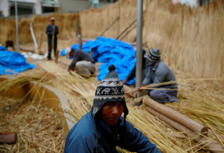 Aymara builders work on the 'Viracocha III', a boat made only from the totora reed, as it is being prepared to cross the Pacific from Chile to Australia on an expected six-month journey, in La Paz, Bolivia, October 19, 2016. REUTERS/David Mercado