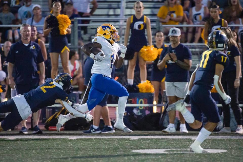 The Grant Pacers’ Wayshawn Parker (1) runs for a first down before stepping out of bounds in the first half on Friday at Oak Ridge High School.