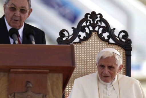 Pope Benedict XVI (R) listens to Cuban President Raul Castro delivering a speech during a ceremony following his arrival at Antonio Macedo airport, in Santiago de Cuba