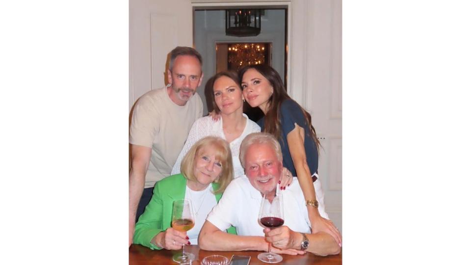 Victoria Beckham posing with her sister Louise, brother and parents