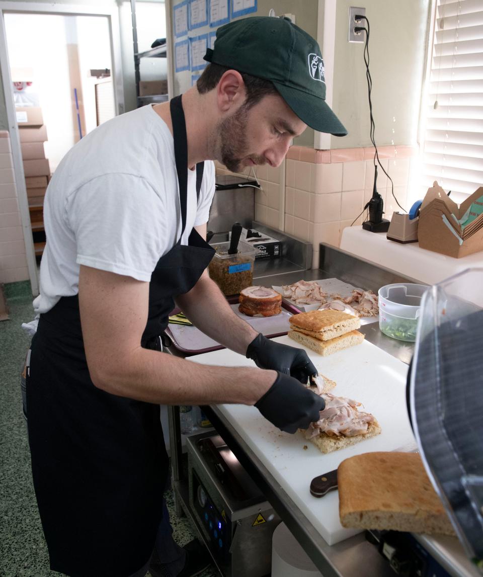 Alex Lamonte creates one of his signature Italian sandwiches, the Il Maestoso, on Thursday, Jan. 11, 2024. Lamonte and his wife, Ashley, have expanded their gelateria, Lamonte Gelato, to include a Tuscan panini shop, A Mano Panino.