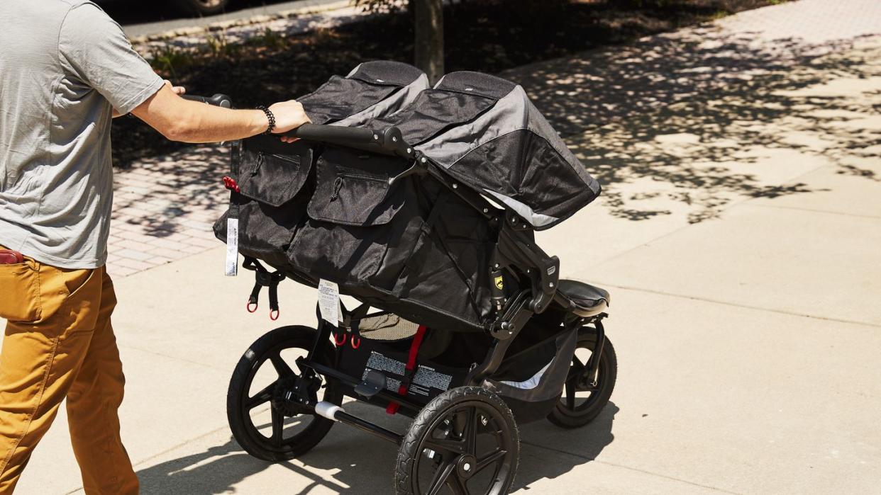 bab double stroller being pushed up a sidewalk