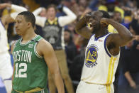 Golden State Warriors forward Draymond Green (23) celebrates next to Boston Celtics forward Grant Williams (12) during the first half of Game 1 of basketball's NBA Finals in San Francisco, Thursday, June 2, 2022. (AP Photo/Jed Jacobsohn)