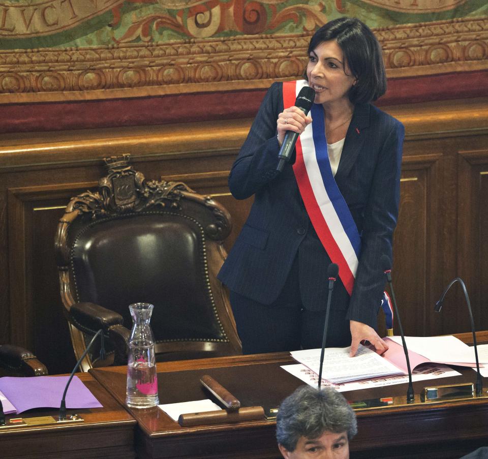 The new mayor of Paris Anne Hidalgo, wearing the mayoral sash in the color of the French Republic, speaks after her election, in Paris, Saturday, April 5, 2014. The first woman mayor of Paris has taken office, hailing a “great advance for all women” and saying she feels the weight of responsibility in her new job. (AP Photo/Michel Euler)