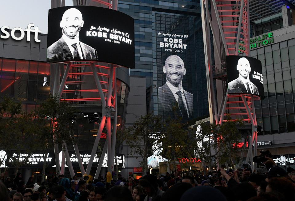 Electronic signs honor Kobe Bryant at L.A. Live in Los Angeles on Sunday, Jan. 26, 2020, following reports of his death in a helicopter crash in southern California. (AP Photo/Michael Owen Baker)