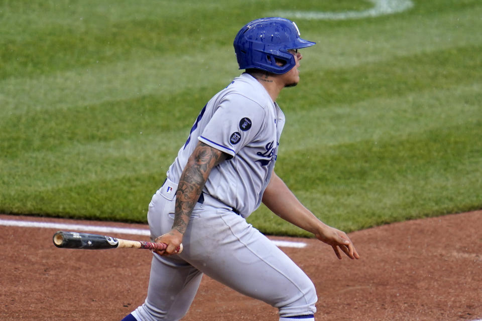 Los Angeles Dodgers starting pitcher Julio Urias singles off Pittsburgh Pirates starting pitcher Mitch Keller, driving in two runs, during the third inning of a baseball game in Pittsburgh, Thursday, June 10, 2021. (AP Photo/Gene J. Puskar)