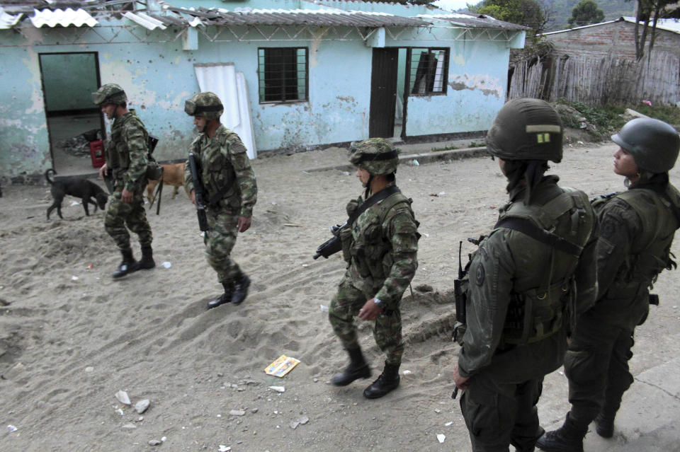 Soldiers patrol the streets of Toribio, southern Colombia, Tuesday, July 10, 2012. Rebels of the Revolutionary Armed Forces of Colombia (FARC) attacked the police station of Toribio last week. Colombia's President Juan Manuel Santos will visit the town on Wednesday. (AP Photo/Juan Bautista)