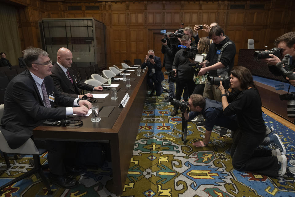 Russia's agent Gennady Kuzmin, ambassador-at-large of the Russian Foreign Ministry, left, waits for the United Nations top court to rule in The Hague, Netherlands, Wednesday, Jan. 31, 2024. The United Nations’ top court is preparing to rule on Ukraine’s allegations that Russia bankrolled separatist rebels in the country’s east a decade ago and has discriminated against Crimea’s multiethnic community since its annexation of the peninsula. The legally binding final ruling due on Wednesday is the first of two expected decisions from the International Court of Justice linked to the conflict between Russia and Ukraine that exploded into a full-blown war in February 2022. (AP Photo/Peter Dejong)