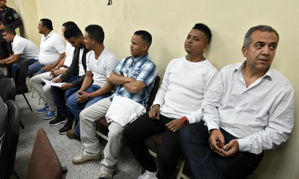 The former manager of Desa Sergio Rodríguez, right, and the seven other people accused of killing the Honduran environmental leader Berta Cáceres, wait to hear their sentence at a courtroom in Tegucigalpa.