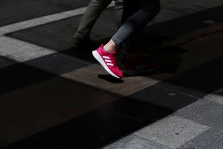 FILE PHOTO: A woman wears Adidas sports shoes in central Madrid