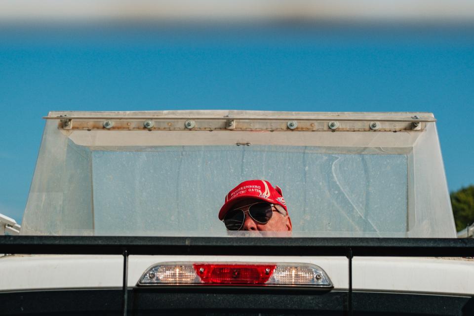 Harness racing starter Mike Woebkenberg waits in the bubble as harness racers finish warmup laps during the Tuscarawas County Fair.