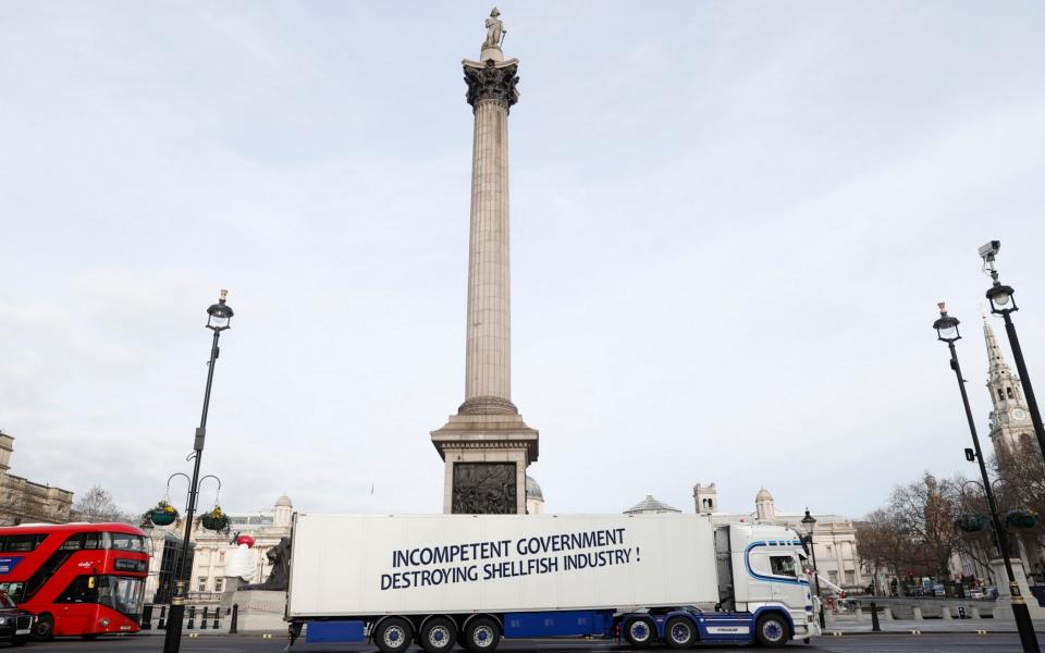 A truck saying 'Incompetent Government Destroying Shellfish Industry" drives around Trafalgar Square - AP