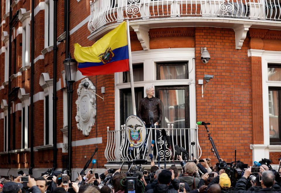 WikiLeaks founder Julian Assange gestures on the balcony of the Ecuadorian embassy prior to speaking, in London, (AP)