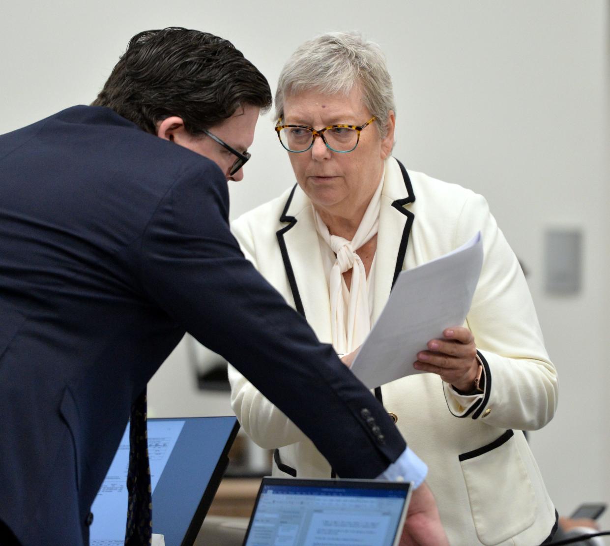 David Hughes, left, and Patricia Crauwels, attorneys for Johns Hopkins All Children's Hospital Thursday, discuss a defense exhibit that they are asking to submit into evidence on Oct. 19, 2023 at the South County Courthouse in Venice, Florida. The Kowalski family is suing Johns Hopkins All Children's Hospital for false imprisonment, negligent infliction of emotional distress, medical negligence, battery, and other claims more than a year after the family matriarch, Beata Kowalski, took her life following allegations she was abusing her daughter, Maya Kowalski. Pool photo/Mike Lang/Sarasota Herald-Tribune