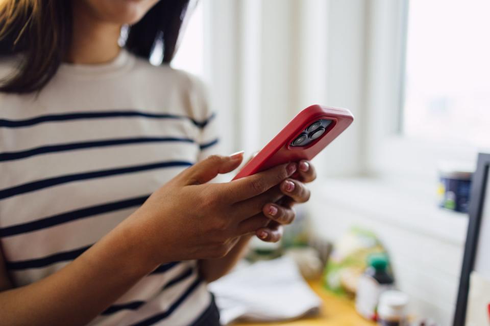 an unrecognizable woman checking her phone