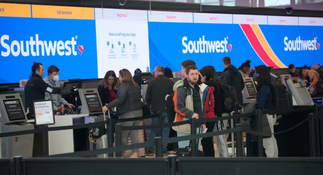 FILE - Travelers queue up at the check-in counters for Southwest Airlines in Denver International Airport on Dec. 30, 2022.