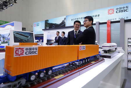 Staff members stand at CRRC's booth at an exhibition during the World Intelligence Congress in Tianjin, China May 16, 2019. REUTERS/Jason Lee