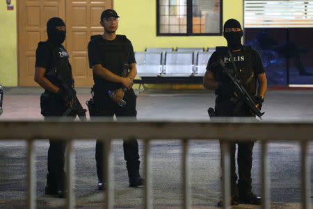 Member of the Royal Malaysia Police special operation forces stand guard at the gate of the morgue at Kuala Lumpur General Hospital where Kim Jong Nam's body is held for autopsy in Malaysia, February 21, 2017. REUTERS/Athit Perawongmetha