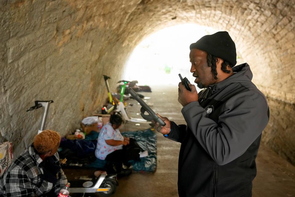 HEART's L.D. Davis talks on a radio while answering calls for service downtown last month. HEART members may be asked to talk to someone who is agitated or connect someone to homeless services.