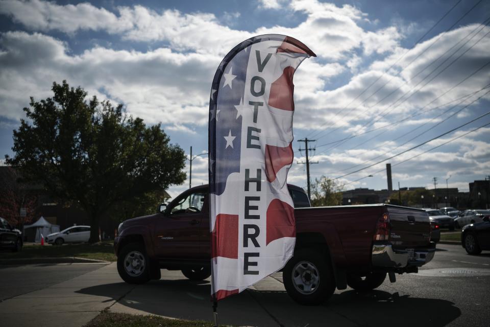 A truck turns into Kenosha's municipal offices for drive-thru early voting in Kenosha, Wis., Friday, Oct. 30, 2020. Trump has made protest violence in Kenosha and other American cities, a key part of his re-election campaign, linking violence to Democrats and saying it would spread dramatically if Democratic nominee and former Vice President Joe Biden was to defeat him on Election Day. (AP Photo/Wong Maye-E)