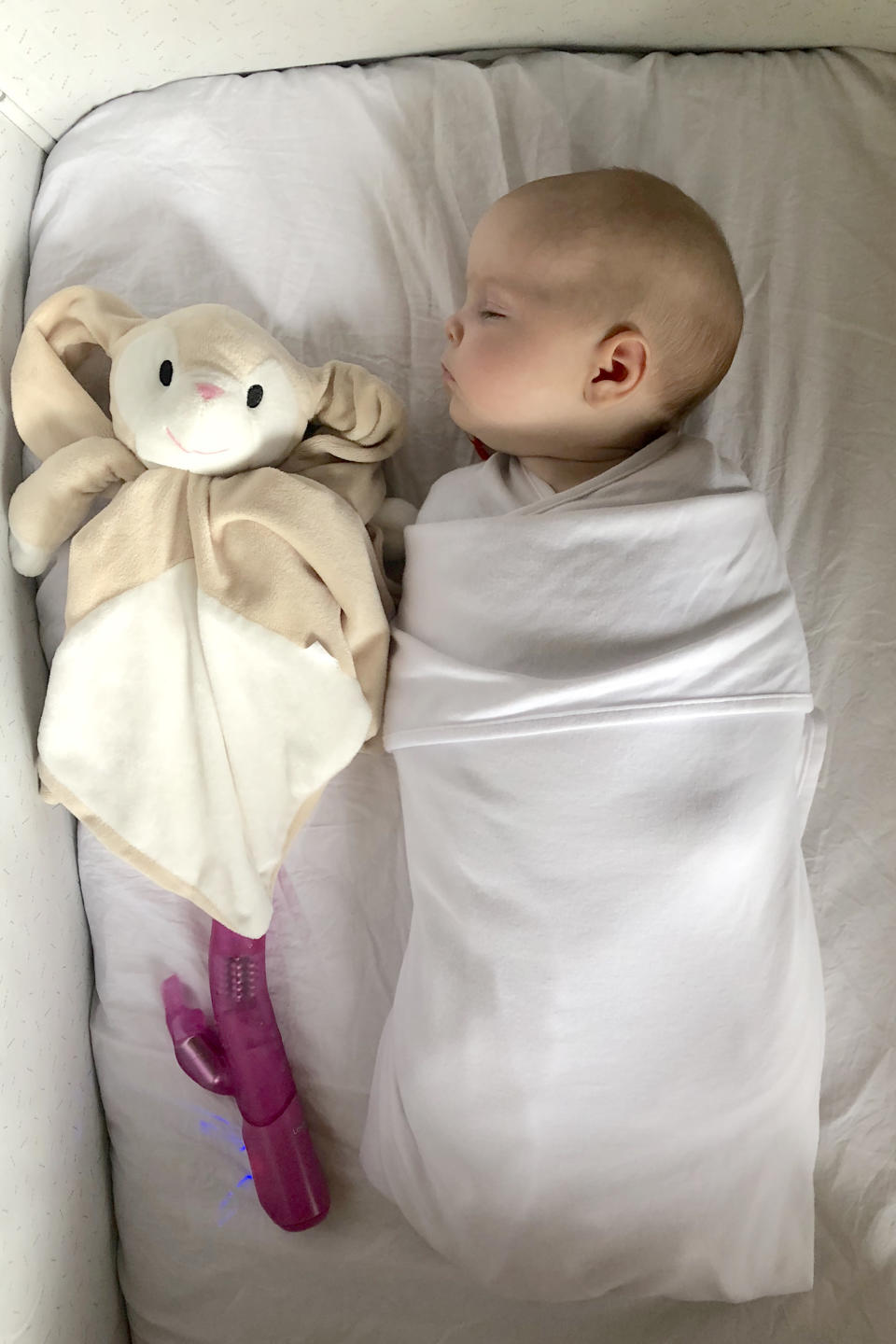 Baby Lucie fast asleep with the vibrator [Photo: Caters News Agency]