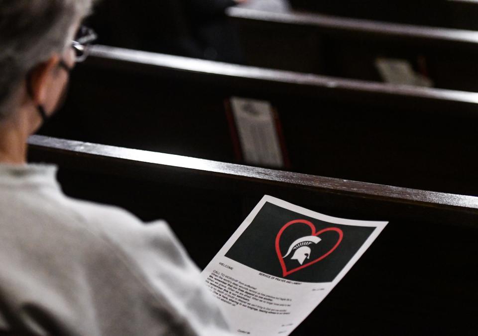 The Michigan State University logo with a heart around it seen on a church bulletin Tuesday, Feb. 14, 2023, during the Service of Prayer and Lament at the Edgewood United Church in East Lansing. The church partnered with the Unitarian Universalist Church of Lansing to honor and pray for the victims and families from Monday's shooting at MSU.