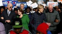 Seven of the Democratic US Presidential candidates walk arm-in-arm with local African-American leaders during the Martin Luther King Jr. (MLK) Day Parade in Columbia