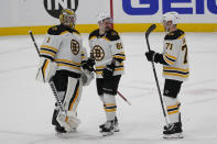 Boston Bruins goaltender Jeremy Swayman (1), defenseman Dmitry Orlov (81) and left wing Taylor Hall (71) celebrates after defeating the Florida Panthers during the third period of Game 4 of an NHL hockey Stanley Cup first-round playoff series, Sunday, April 23, 2023, in Sunrise, Fla. (AP Photo/Marta Lavandier)