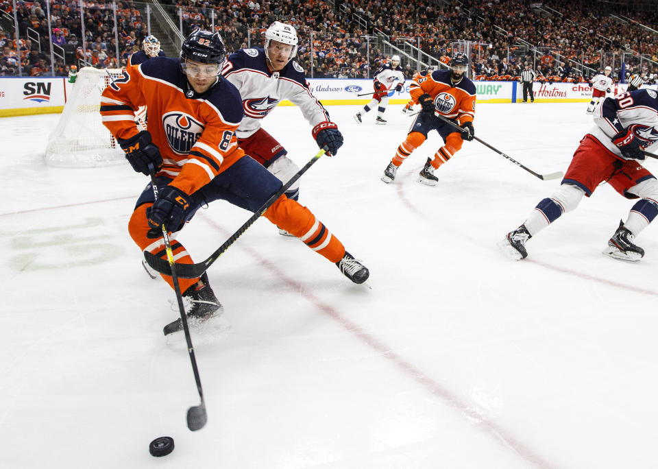 FILE - In this March 7, 2020, file photo, Columbus Blue Jackets center Riley Nash (20) chases Edmonton Oilers' Caleb Jones (82) during the third period of an NHL hockey game in Edmonton, Alberta. The Chicago Blackhawks have traded two-time Norris Trophy winner Duncan Keith to the Oilers for young defenseman Jones and a conditional 2022 third-round draft pick. (Jason Franson/The Canadian Press via AP, File)