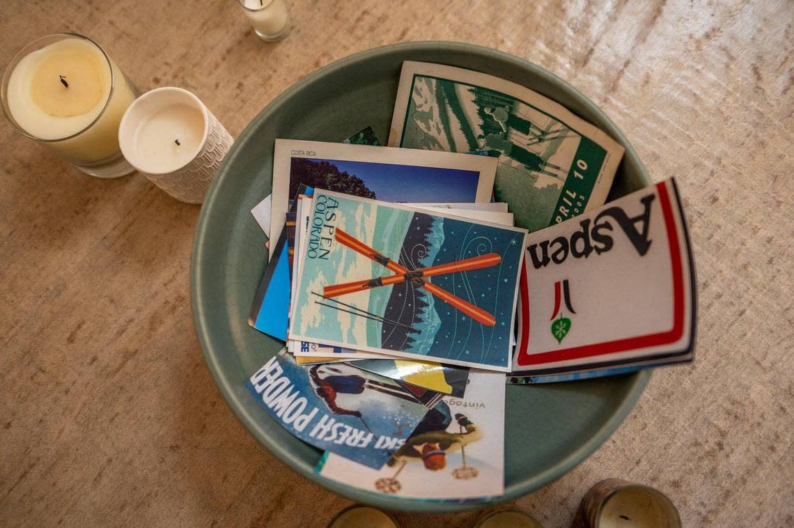 Suzi Sanderson displays a collection of postcards from her life in Aspen, Colorado, in a bowl in her home office.