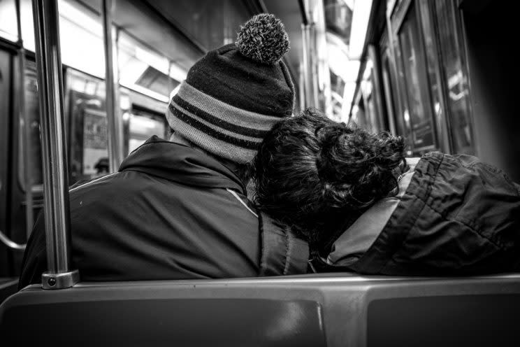 Couple on subway from behind