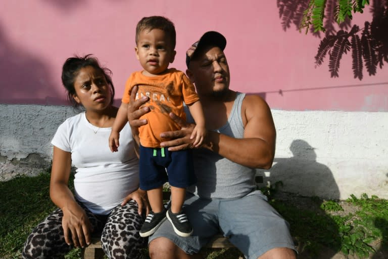 Rolando Bueso (R) and his wife Adalicia (L) say their son Johan (C) has suffered from health and sleep problems since he was returned from the US