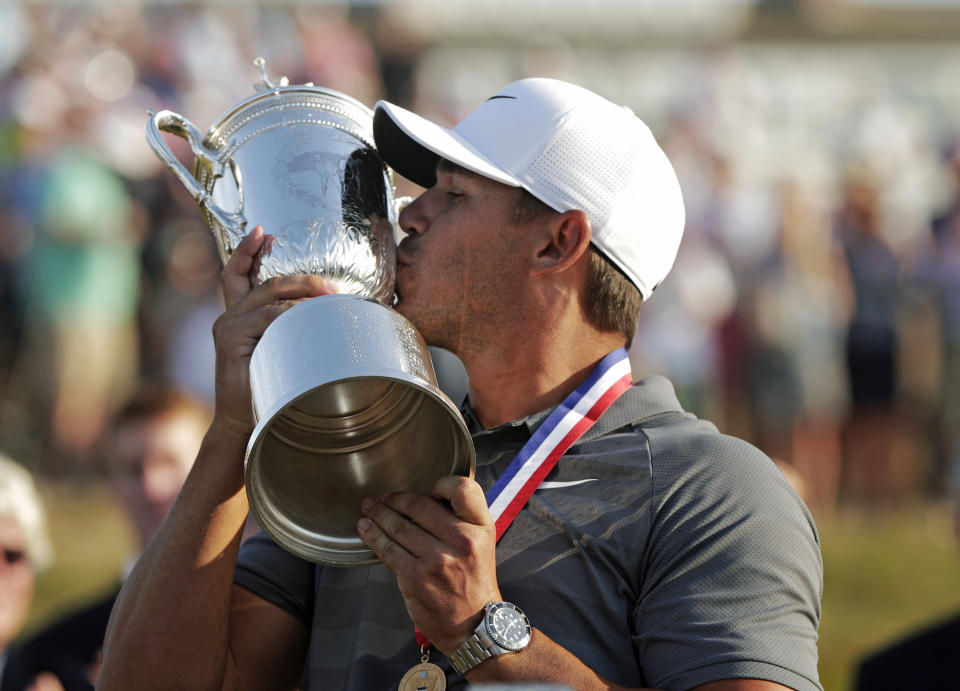 Brooks Koepka kisses the Golf Champion Trophy after winning the U.S. Open. (AP)