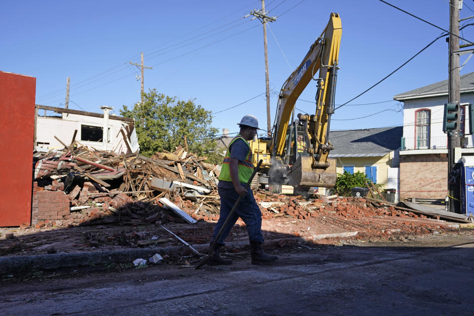Workers remove debris from an unoccupied structure that collapsed yesterday as Hurricane Zeta passed through in New Orleans, Thursday, Oct. 29, 2020. The storm left much of the city and metro area without power. (AP Photo/Gerald Herbert)
