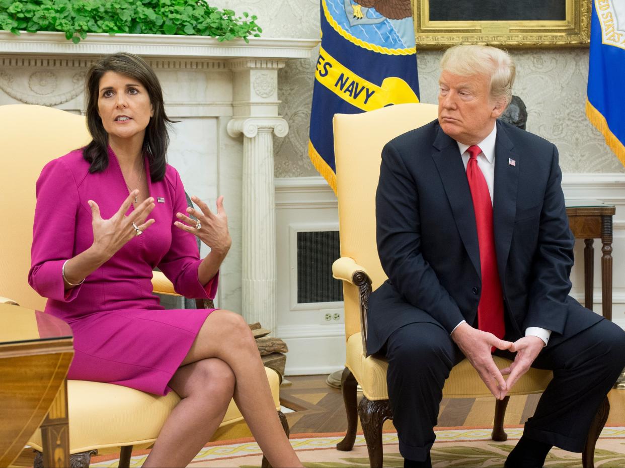 <p>Nikki Haley (L) speaks beside US President Donald J Trump (R) in the Oval Office of the White House in Washington, DC, on 9 October 2018</p> ((EPA))