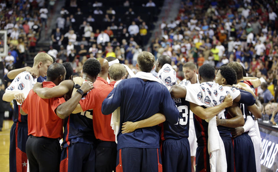 Team USA players and coaches huddle after Indiana Pacers' Paul George was injured during the USA Basketball Showcase game Friday, Aug. 1, 2014, in Las Vegas. (AP Photo/John Locher)