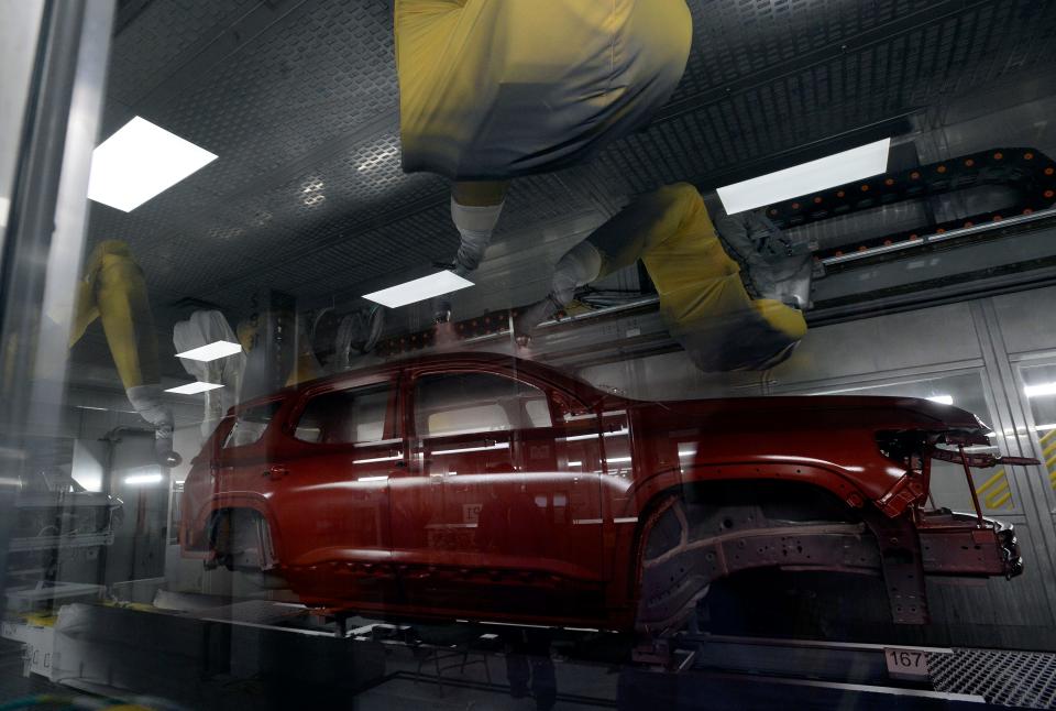 A General Motors vehicle is sprayed with spray painted in the new GM Spring Hill paint shop Thursday, April 6, 2023 in Spring Hill, Tenn. The new paint shop, which began operating at full capacity this week, is more environmentally friendly.    