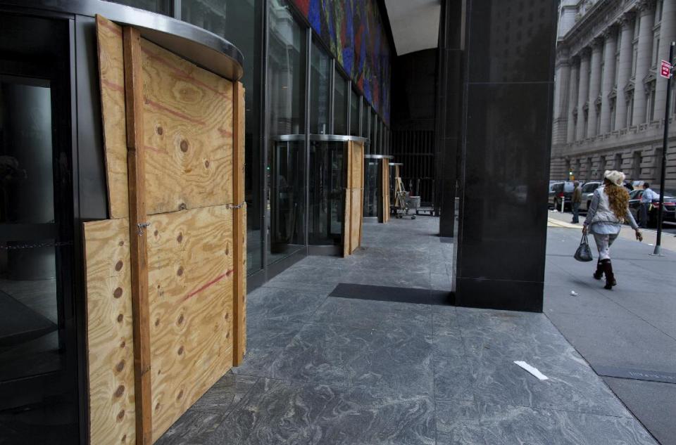 Plywood covers the revolving doors in preparation for Hurricane Sandy at the 2 Broadway building of Lower Manhattan in New York, Sunday, Oct. 28, 2012. Areas along the Northeast Coast are preparing for the arrival of the hurricane and a possible flooding storm surge. (AP Photo/Craig Ruttle)